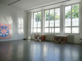 A large room, with three paintings. One big pink one, the others smaller, one white, one brownish on the ground. Anna Slobodnik 2015. 