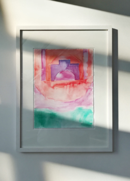 A framed watercolor painting of a violet castle like house on red ground and green in the lower part of the painting. Anna Slobodnik, 2018. 