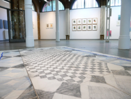 Close up of an assembled checkered drawing lying on the floor. 