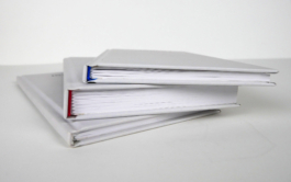 Three grey books over each other. 