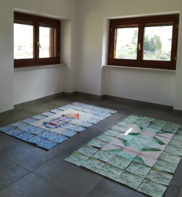 Two assembled paintings on paper on the floor of a small room. On the paintings tiles in green and blue with a motive in the middle. Anna Slobodnik, 2018. 