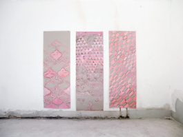 Three wallpaper panels with pink patterns on them. 