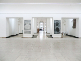 View of the UdK Berlin entrance, on the pillows two large size etchings of carpets in black and dark blue. Anna Slobodnik, 2017. 