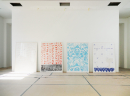 Four framed paintings leaned on the wall. From left to right: A white Painting with a light pattern, a painting with read pattern and black floor tiles, one with a blue floral pattern und the last one with white blue patterned tiles. Anna Slobodnik 2016. 