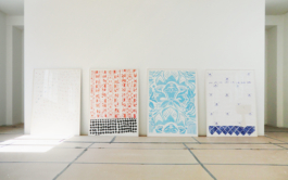 Four framed paintings leaned on the wall. From left to right: A white Painting with a light pattern, a painting with read pattern and black floor tiles, one with a blue floral pattern und the last one with white blue patterned tiles. Anna Slobodnik 2016. 