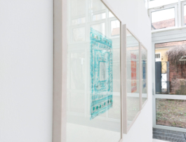 Close up of three framed stone prints. 