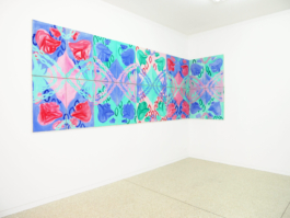 A floral frieze in red blue and green made out of several canvases and going around the corner. 