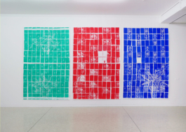Three high scale paper works depicting tiles in red blue and green. 
