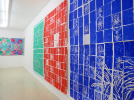 Close up of paperworks depicting tiles in blue red and green. 