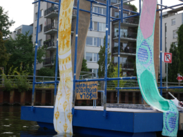 Green and yellow ornaments on paintings on a raft. A close up. 