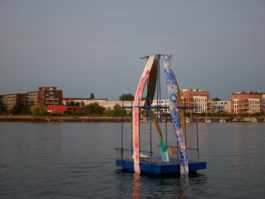 A red and blue patterned painting on a raft in the evening light. 