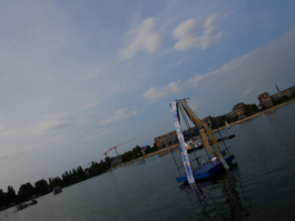 A raft further away with paintings on it and the sky behind it. 