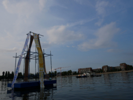 A raft on the Rummelsburger Bucht. Paintings hang down on it. 