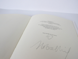 An open signed book.