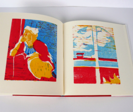 An open book with two woodcuts in red blue and yellow.