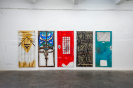 Frontal view of the hanging of five paintings of doors by Anna Slobodnik. 