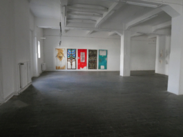 View of the exhibition space of Gestures of Continuity with Anna Slobodniks paintings hanging on the back of the room. 