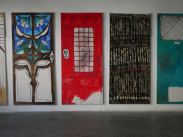 A close up of the door paintings of Anna Slobodnik, a red one in the middle. 