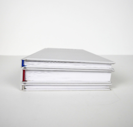 Three books on top of each other. The Headbands in red blue and white.