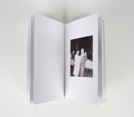 An open book with a photograph of a couple dancing.