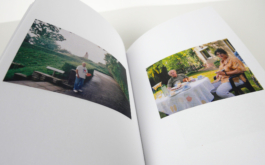 An open book with a photograph on each page.