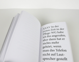 An open book with a big lettered text to the right.