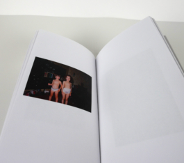 An open book with a photograph of two children to the left.