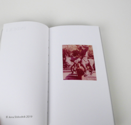 An open book with the photograph of a man in a traditional dress on the right page.