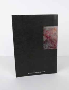 A black book standing from the back. 