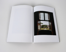 An open book with a window on the right page. 