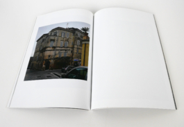 An open book with a photograph of a building on the left. 