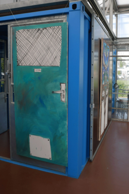 Installation view of two paitings of doors one around a corner. 