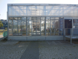 View of a glassbuilding and a painting of a glass in it. 