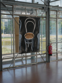 A painting of a chair on black next to a fire extinguisher in front of wall of glass. 