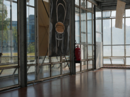 Side view of a painting of a chair on black ground. Light falling in from the other side. 