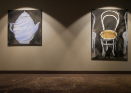 A painting of a blue teapot hanging next to a painting of a chair in viennese style. 