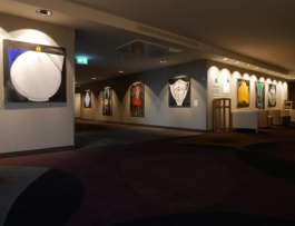 Exhibition view of paintings of teapots and chairs by Anna Slobodnik. 