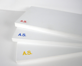Three white books on top of each other.