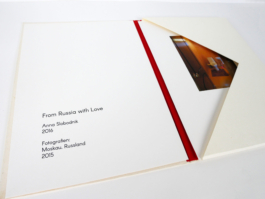 An open folder with a title on the left and a photo on the right side. 