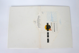 A folder with an envelope with a cat on it. 