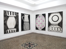 Four paintings of vases hanging around a corner, the second painting from the right has pink dots on it, the others are black and white. 