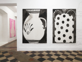 Two paintings of jugs in black and white next to a passageway with a pink painting in the background. 