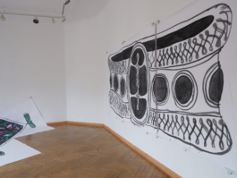 A big painting of a bracelet on the right of the picture and a small edge of another painting to the right 